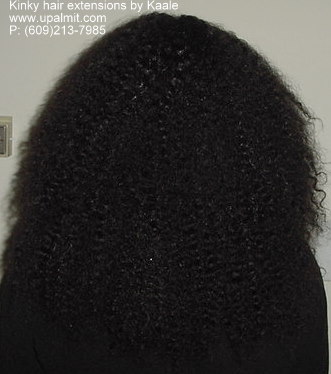 Kinky hair extensions, and hair weaves, back view.