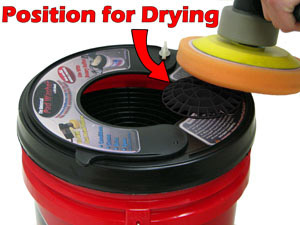 Dry pads by spinning them against the Grid Extension positioned on the outside of the bucket.