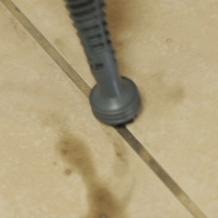 The grout attachment cleans grime out of grout lines.