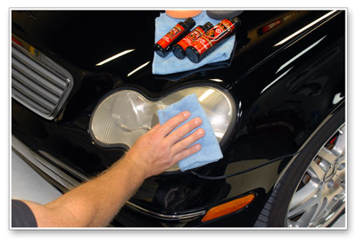 Buff off Wolfgang Plastik Lens Cleaner with a soft microfiber towel.