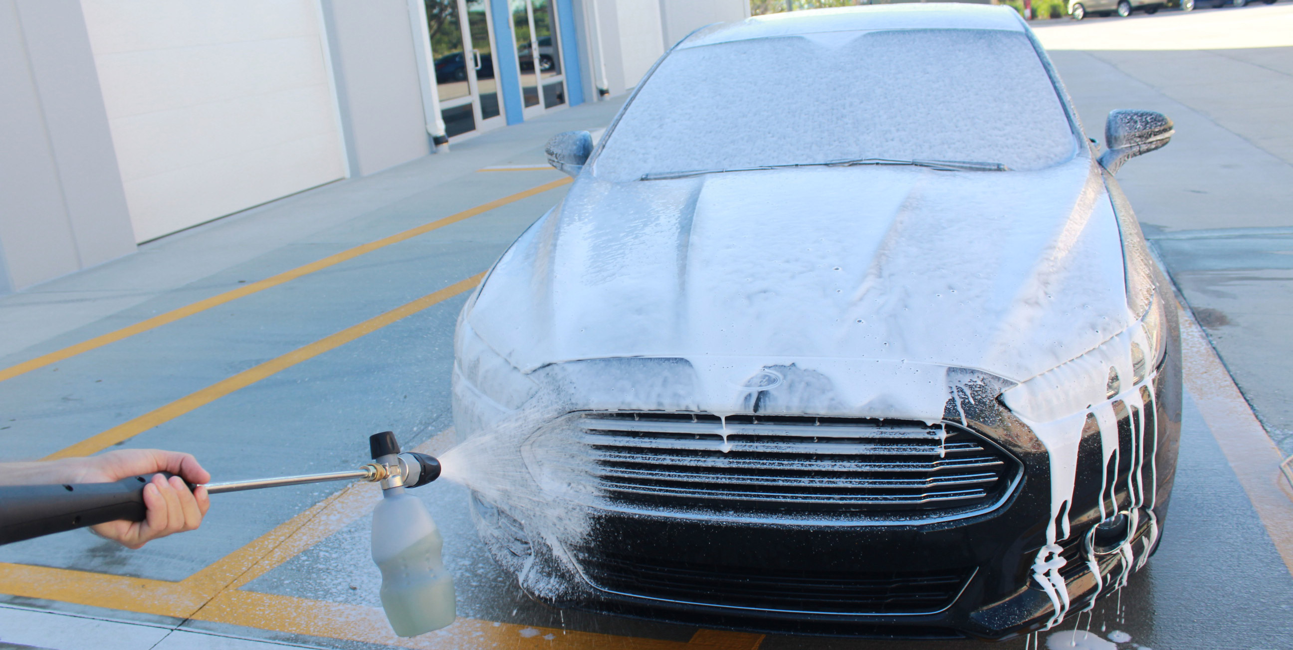 We are just going to spray and evenly coat the entire car surface with a thick helping of road grime stripping suds!
