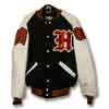 This is a simple yet beautiful letter jacket with black wool body and white leather sleeves. An old-english letter is on the front along with an embroidered name.  The sleeves of the letterman jacket have a class of chenille patch and a chenille chevron patch.